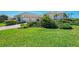 Beautiful single Gathering home with a three car garage, lush lawn and garden area at 3574 Pennyroyal Rd, Port Charlotte, FL 33953
