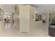 Hallway featuring neutral walls, tiled floors, and a view of the living spaces at 3574 Pennyroyal Rd, Port Charlotte, FL 33953