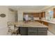 Island kitchen featuring stainless appliances, granite countertops, and convenient breakfast bar at 3574 Pennyroyal Rd, Port Charlotte, FL 33953
