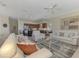 Inviting living space with kitchen in background, neutral tones, and comfortable furnishings at 3574 Pennyroyal Rd, Port Charlotte, FL 33953
