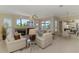 Bright living room featuring a fireplace, large windows, and sliding doors to outdoor entertaining area at 3574 Pennyroyal Rd, Port Charlotte, FL 33953