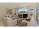 Bright living room with a fireplace and large picture window at 3574 Pennyroyal Rd, Port Charlotte, FL 33953