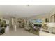 Open concept living room featuring neutral decor, tile floors, and a view of the outdoor patio at 3574 Pennyroyal Rd, Port Charlotte, FL 33953
