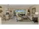 Living room showcasing sliding glass doors to the outdoor patio, neutral decor, and tile floors at 3574 Pennyroyal Rd, Port Charlotte, FL 33953