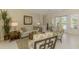 Inviting living room boasts neutral tones, comfortable seating, and a sunlit ambiance at 3574 Pennyroyal Rd, Port Charlotte, FL 33953