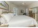 Spacious main bedroom with a four-poster bed, elegant furnishings, and access to the lanai at 3574 Pennyroyal Rd, Port Charlotte, FL 33953