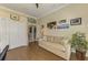 Cozy office with hardwood floors, comfortable seating, and closet for storage at 3574 Pennyroyal Rd, Port Charlotte, FL 33953