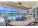 Covered patio features a beautiful view of the pool and surrounding greenery at 3574 Pennyroyal Rd, Port Charlotte, FL 33953