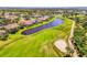 A beautiful golf course community with a blue pond in the foreground at 3574 Pennyroyal Rd, Port Charlotte, FL 33953