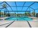 Sparkling pool enclosed by a screen offering captivating water views and lush landscaping at 3574 Pennyroyal Rd, Port Charlotte, FL 33953