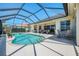 Beautiful screened pool area with serene lake views, outdoor seating, and lush landscaping at 3574 Pennyroyal Rd, Port Charlotte, FL 33953