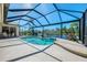 Sparkling pool enclosed by a screen offering captivating water views and lush landscaping at 3574 Pennyroyal Rd, Port Charlotte, FL 33953