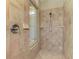 Tiled stand-up shower with glass window and shower head with handheld sprayer at 3574 Pennyroyal Rd, Port Charlotte, FL 33953