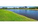 Scenic view of a calm waterway bordered by lush greenery and manicured lawns at 3574 Pennyroyal Rd, Port Charlotte, FL 33953