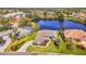 Beautiful aerial view of a single-story home situated on a lush lot with a tranquil lake in the Riverwood community at 3615 Pennyroyal Rd, Port Charlotte, FL 33953