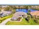Aerial view of home, highlighting the lake view and well manicured lawn at 3615 Pennyroyal Rd, Port Charlotte, FL 33953