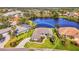 Beautiful aerial view of a single-story home situated on a lush lot with a tranquil lake in the Riverwood community at 3615 Pennyroyal Rd, Port Charlotte, FL 33953