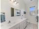 Well-lit bathroom with double sink vanity and large mirror, ready to be used at 3615 Pennyroyal Rd, Port Charlotte, FL 33953