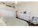 Bedroom with coastal accents, hardwood floors, and bright closet doors at 3615 Pennyroyal Rd, Port Charlotte, FL 33953