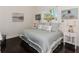 Charming bedroom showcasing coastal decor, wood floors, and ample natural light at 3615 Pennyroyal Rd, Port Charlotte, FL 33953