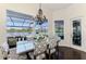 Dining area with a view of the pool with modern furniture and natural light, perfect for entertaining at 3615 Pennyroyal Rd, Port Charlotte, FL 33953
