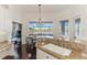 Dining area with large windows, stylish table and chairs, granite counters, and views of the outdoor space at 3615 Pennyroyal Rd, Port Charlotte, FL 33953