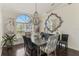 Elegant dining room with chandelier, large window, stylish decor and a dining table set for entertaining at 3615 Pennyroyal Rd, Port Charlotte, FL 33953
