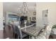 Open-concept dining area with chandelier, seamlessly connected to the living room, ideal for gatherings at 3615 Pennyroyal Rd, Port Charlotte, FL 33953