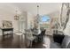 Elegant dining room with chandelier, decorative mirrors, and large window, adding a touch of sophistication at 3615 Pennyroyal Rd, Port Charlotte, FL 33953