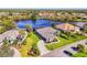Well-manicured lawn of a single-story home nestled next to a tranquil lake in the sought-after Riverwood community at 3615 Pennyroyal Rd, Port Charlotte, FL 33953