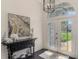 Inviting foyer with decorative painting, high ceilings, and dark hardwood floors at 3615 Pennyroyal Rd, Port Charlotte, FL 33953