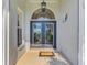 Elegant front door with decorative glass, illuminated by a decorative light fixture at 3615 Pennyroyal Rd, Port Charlotte, FL 33953