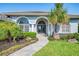 Close up of the front entrance of the home, with arched windows and a brick path at 3615 Pennyroyal Rd, Port Charlotte, FL 33953