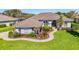 Beautiful single-story home featuring a well-manicured lawn, lush landscaping and a tile roof at 3615 Pennyroyal Rd, Port Charlotte, FL 33953