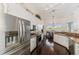 Modern kitchen features stainless steel appliances, granite countertops, white cabinets, and an adjacent dining area at 3615 Pennyroyal Rd, Port Charlotte, FL 33953
