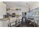Bright kitchen area with breakfast bar, tile backsplash, stainless steel appliances, and open layout at 3615 Pennyroyal Rd, Port Charlotte, FL 33953