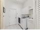 Functional laundry room equipped with washer, dryer, and ample storage space at 3615 Pennyroyal Rd, Port Charlotte, FL 33953