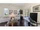 Inviting living room with dark wood floors and sliding glass doors to lanai at 3615 Pennyroyal Rd, Port Charlotte, FL 33953