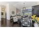 Spacious living room with high ceilings, dark hardwood floors, and views of the lanai at 3615 Pennyroyal Rd, Port Charlotte, FL 33953