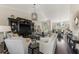 Spacious living room features a dark entertainment center, light furniture, and abundant natural light at 3615 Pennyroyal Rd, Port Charlotte, FL 33953