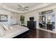 Spacious main bedroom with a sliding glass door to the lanai, tray ceiling, hardwood floors, and natural light at 3615 Pennyroyal Rd, Port Charlotte, FL 33953