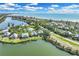Beautiful aerial view of a coastal community with waterfront homes and lush landscaping at 38 Seawatch Lake Dr, Boca Grande, FL 33921