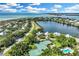 Stunning aerial view of a luxury community with waterfront homes, tennis courts and beach access at 38 Seawatch Lake Dr, Boca Grande, FL 33921
