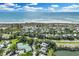 Aerial view of the home, beach access, tennis courts, community pool, and waterway at 38 Seawatch Lake Dr, Boca Grande, FL 33921