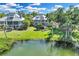 Waterfront home with well-manicured lawn, mature trees, and a serene backyard view at 38 Seawatch Lake Dr, Boca Grande, FL 33921