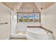 Bathroom featuring a jetted tub, walk in shower, and vaulted wooden plank ceiling at 38 Seawatch Lake Dr, Boca Grande, FL 33921