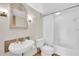 Bathroom with a vanity with decorative mirror, toilet and shower/tub combo at 38 Seawatch Lake Dr, Boca Grande, FL 33921