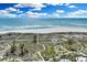 Beautiful beachfront view of soft sand and blue ocean with blue sky and scattered clouds at 38 Seawatch Lake Dr, Boca Grande, FL 33921