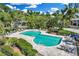 Community pool with lounge chairs and tables surrounded by tropical landscaping at 38 Seawatch Lake Dr, Boca Grande, FL 33921