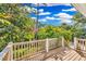 Wooden deck with view of lush tropical landscaping at 38 Seawatch Lake Dr, Boca Grande, FL 33921